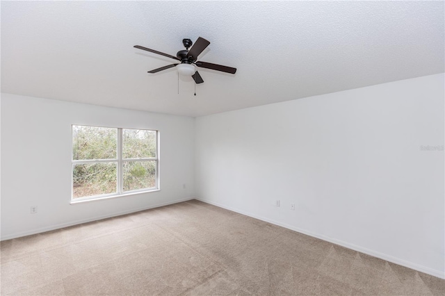 unfurnished room with light carpet, a textured ceiling, and ceiling fan