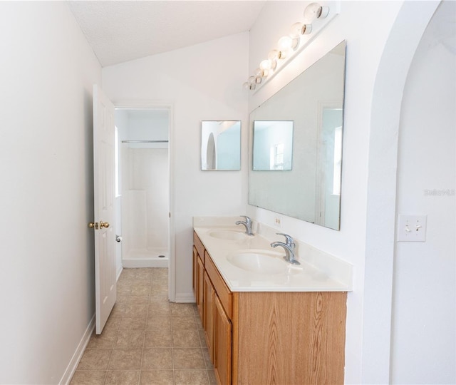 bathroom featuring vanity and a shower