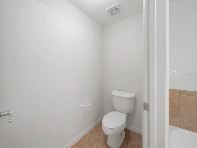 bathroom featuring toilet and tile patterned flooring