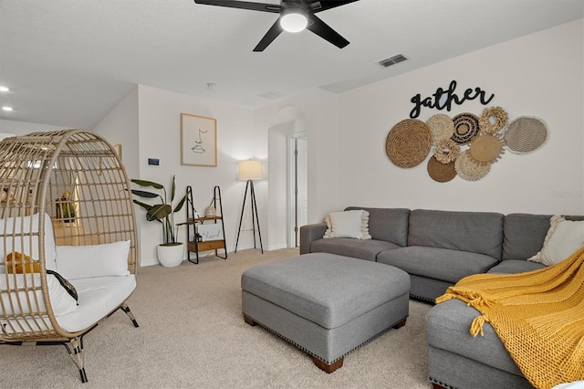 living room with ceiling fan and carpet floors