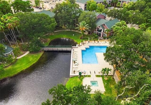 view of pool with a patio area and a water view