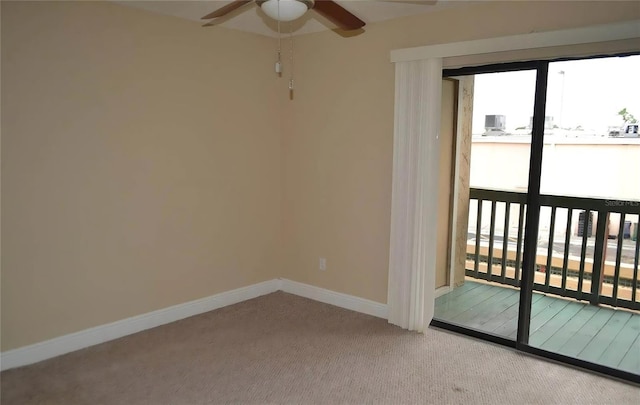 empty room featuring ceiling fan, plenty of natural light, and carpet