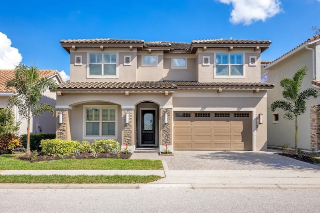 mediterranean / spanish-style home with a garage