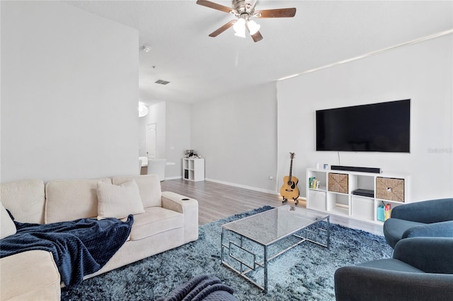 living room featuring hardwood / wood-style floors and ceiling fan