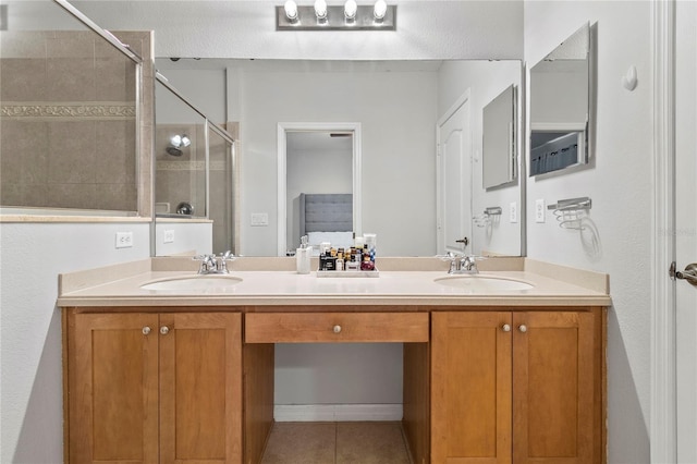 bathroom with tile patterned flooring, vanity, and walk in shower