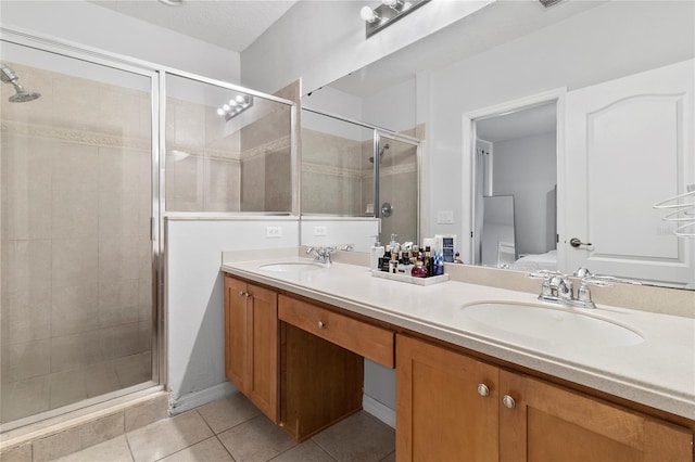 bathroom with tile patterned flooring, vanity, and a shower with shower door