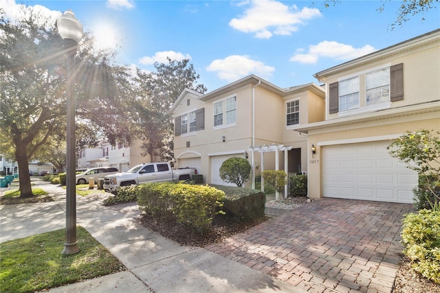 3257 Villa Strada Way, Orlando, FL 32835 - view of front facade featuring an attached garage, decorative driveway, and stucco siding