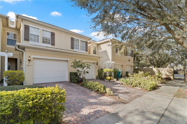 3257 Villa Strada Way, Orlando, FL 32835 - view of front of house featuring a gate, fence, stucco siding, driveway, and a garage