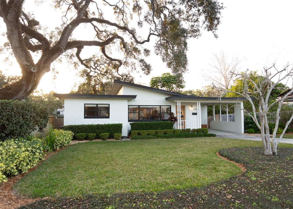 view of front facade with a carport and a front lawn