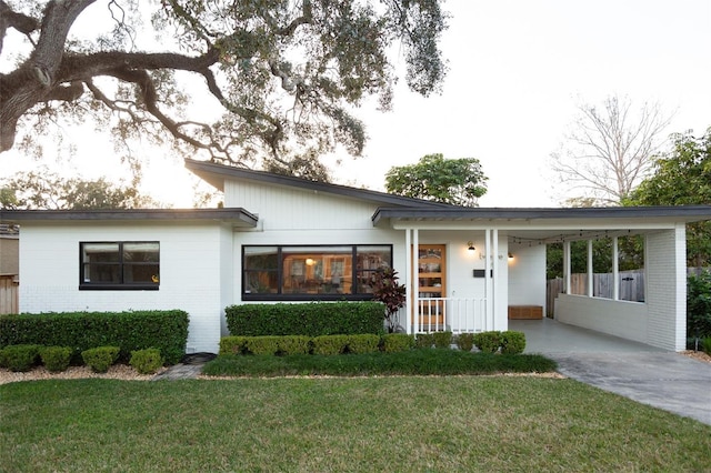 view of front facade with a front lawn and a carport