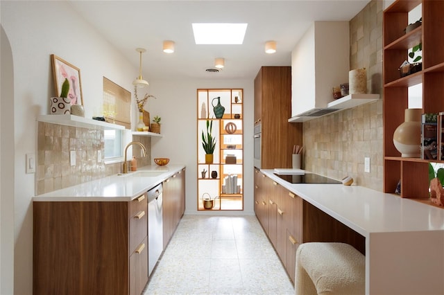 kitchen featuring a skylight, decorative light fixtures, sink, stainless steel dishwasher, and black electric cooktop