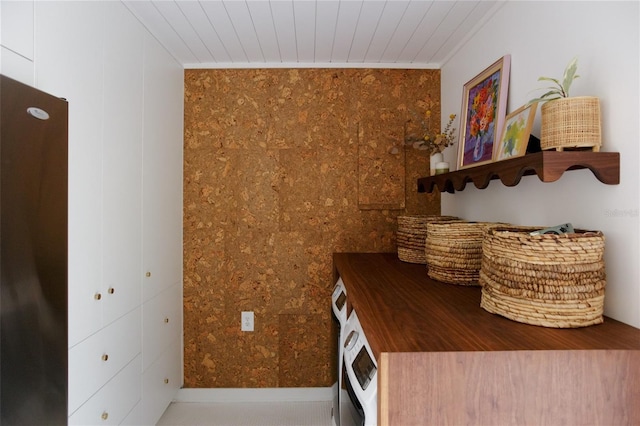 laundry area with wood ceiling, crown molding, and separate washer and dryer