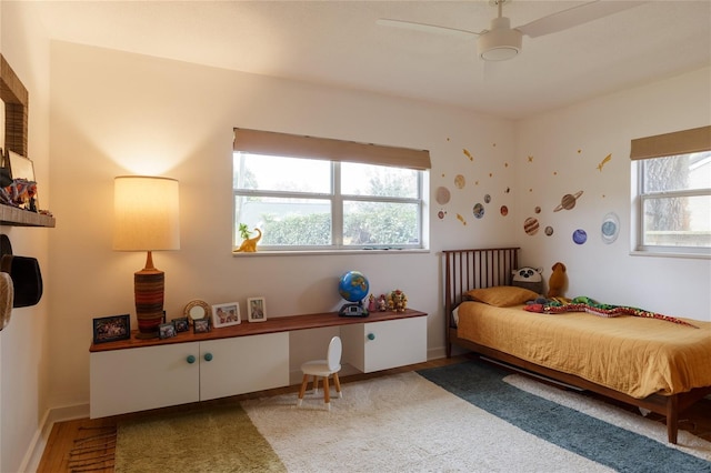 bedroom featuring multiple windows and ceiling fan