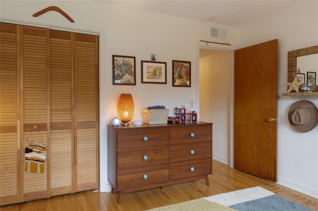 bedroom featuring a closet and light hardwood / wood-style flooring