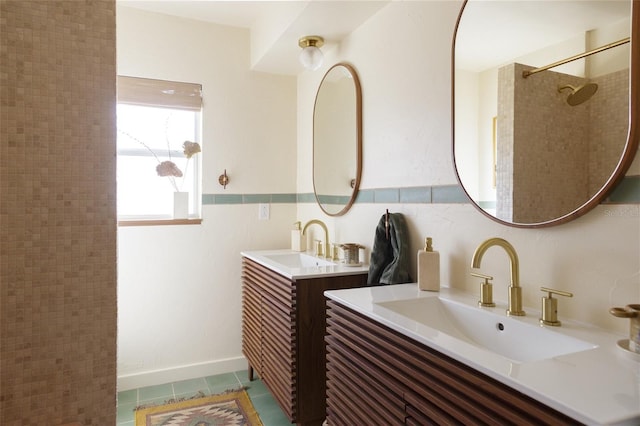 bathroom featuring vanity, tile patterned flooring, tile walls, and tiled shower