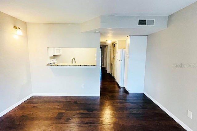 empty room featuring dark hardwood / wood-style flooring