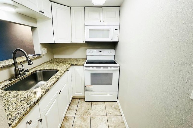 kitchen with sink, white appliances, light stone countertops, and white cabinets