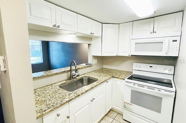 kitchen with white cabinetry, sink, white appliances, and light stone counters