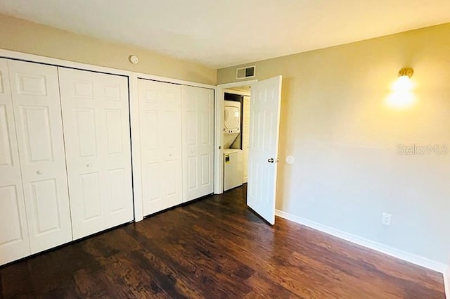 unfurnished bedroom featuring a closet and dark hardwood / wood-style floors