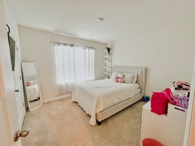 bedroom featuring light colored carpet