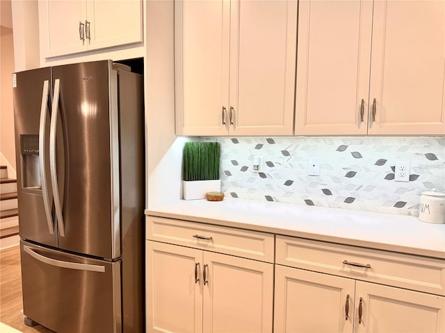 kitchen with stainless steel fridge and backsplash