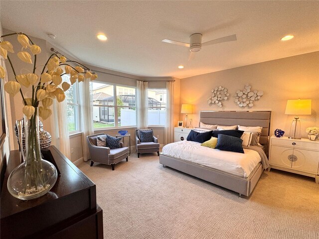 bedroom with ceiling fan and light carpet