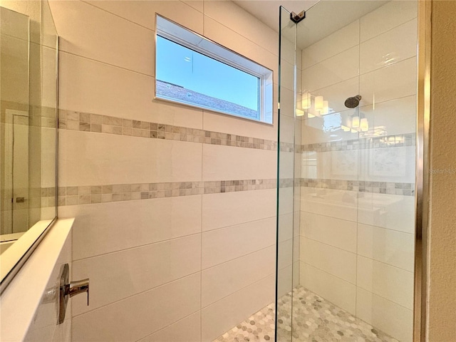 bathroom with tiled shower