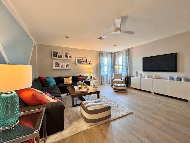 living room featuring hardwood / wood-style flooring and ceiling fan