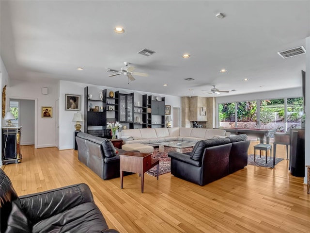 living area featuring a ceiling fan, recessed lighting, visible vents, and light wood-style flooring