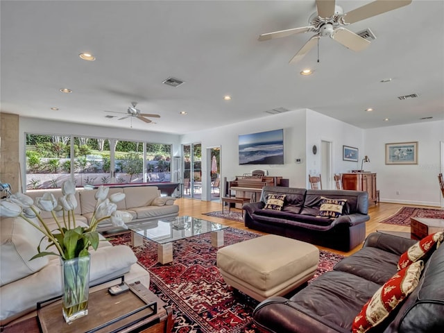 living area featuring recessed lighting, visible vents, and light wood finished floors