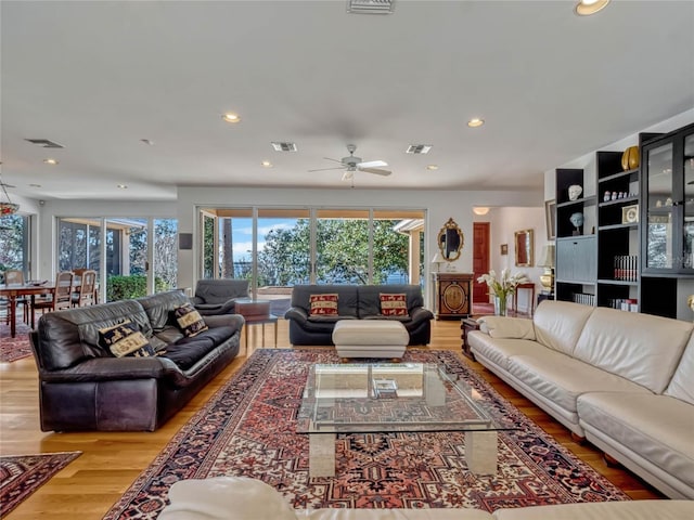 living room with visible vents, wood finished floors, and recessed lighting