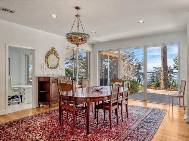 dining room featuring light wood-style floors, visible vents, and recessed lighting