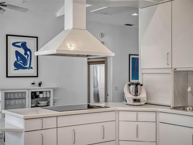 kitchen with visible vents, custom range hood, black electric stovetop, light countertops, and white cabinetry