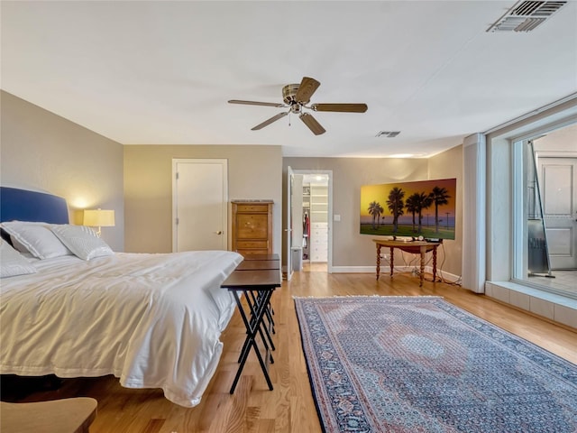 bedroom featuring light wood-type flooring, visible vents, ceiling fan, and baseboards