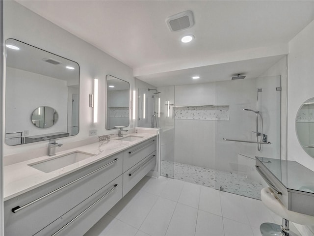 full bath with visible vents, a sink, a shower stall, and double vanity