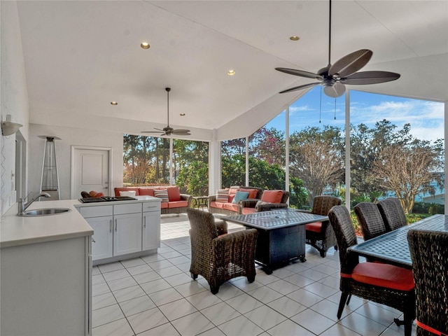 view of patio / terrace featuring an outdoor hangout area, outdoor dining space, a sink, and a ceiling fan