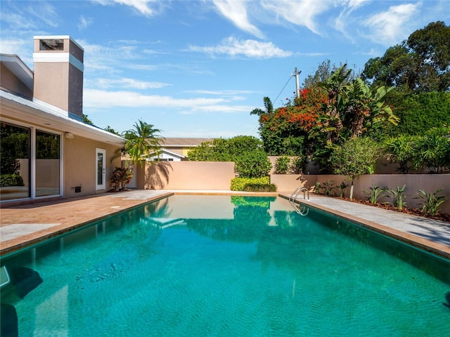 view of swimming pool with a fenced backyard, a fenced in pool, and a patio