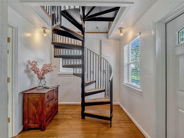 stairway with baseboards and wood finished floors