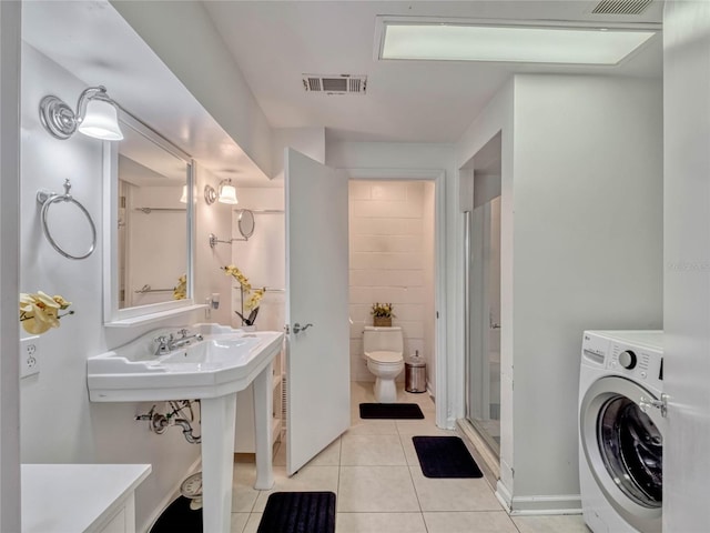 bathroom featuring visible vents, washer / clothes dryer, toilet, and tile patterned floors