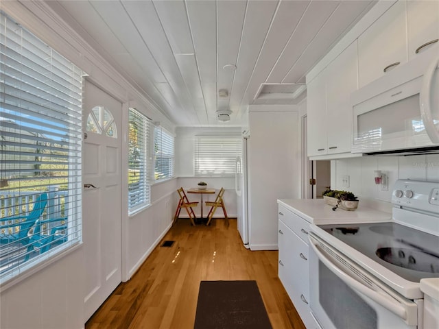 kitchen featuring white appliances, light wood finished floors, white cabinets, wood ceiling, and light countertops