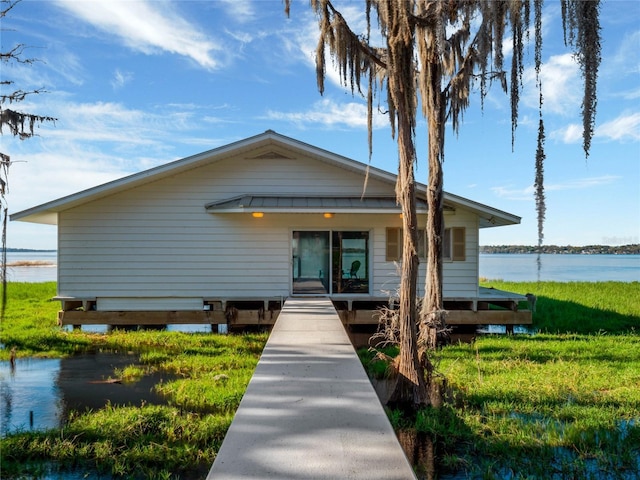 bungalow-style house featuring a water view and a front yard