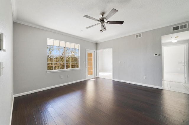 empty room featuring crown molding, dark hardwood / wood-style floors, and ceiling fan