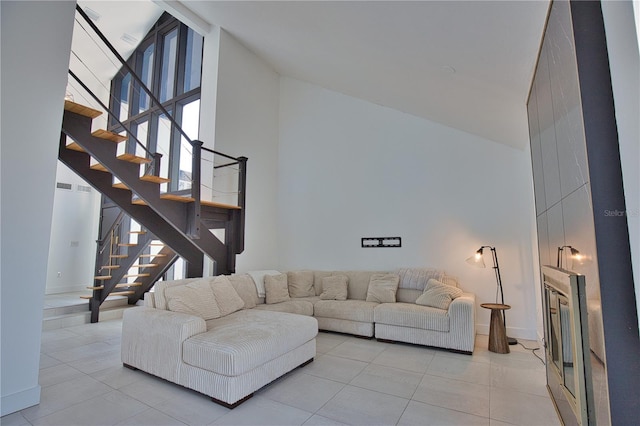 tiled living room featuring high vaulted ceiling