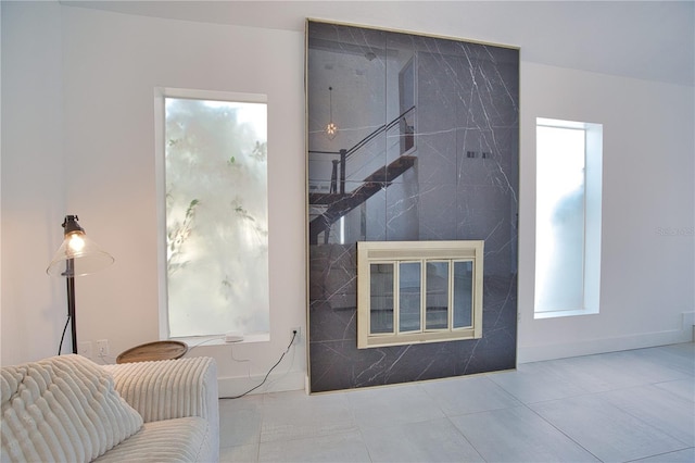 living room with a fireplace, tile patterned flooring, and a wealth of natural light