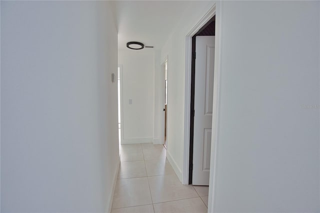 hall with light tile patterned floors