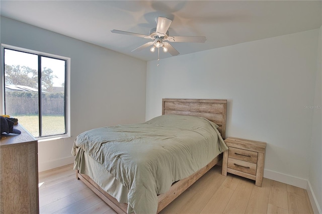 bedroom featuring light hardwood / wood-style floors and ceiling fan