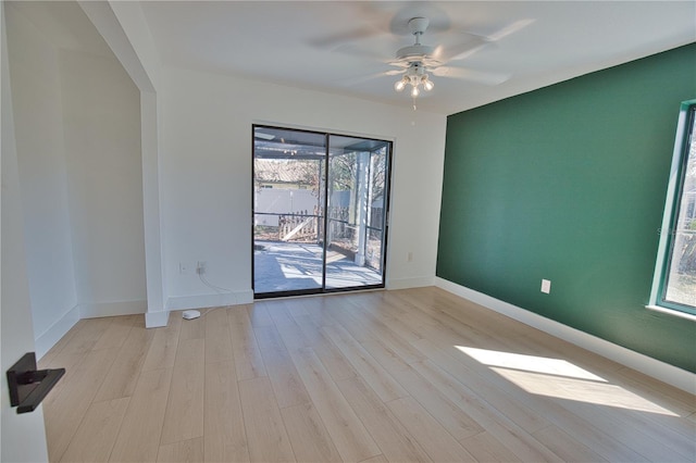 empty room with ceiling fan and light wood-type flooring