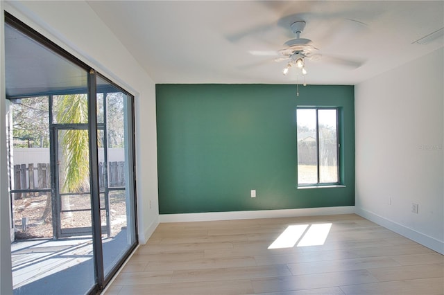 empty room featuring ceiling fan and light hardwood / wood-style flooring