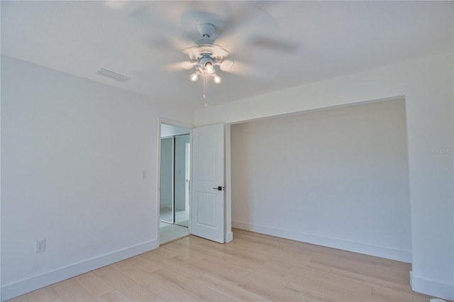 unfurnished room with ceiling fan and light hardwood / wood-style floors