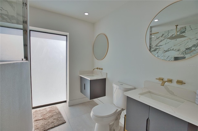 bathroom with vanity, walk in shower, tile patterned floors, and toilet